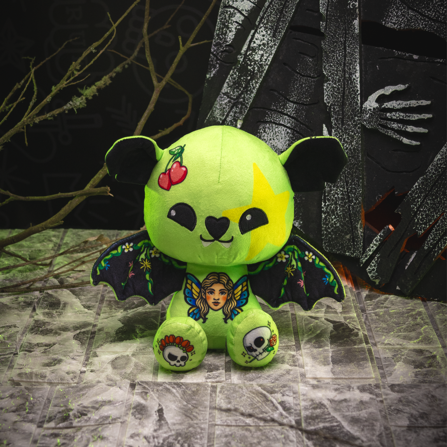 Green plush toy with bat wings and face design on a dark, textured background